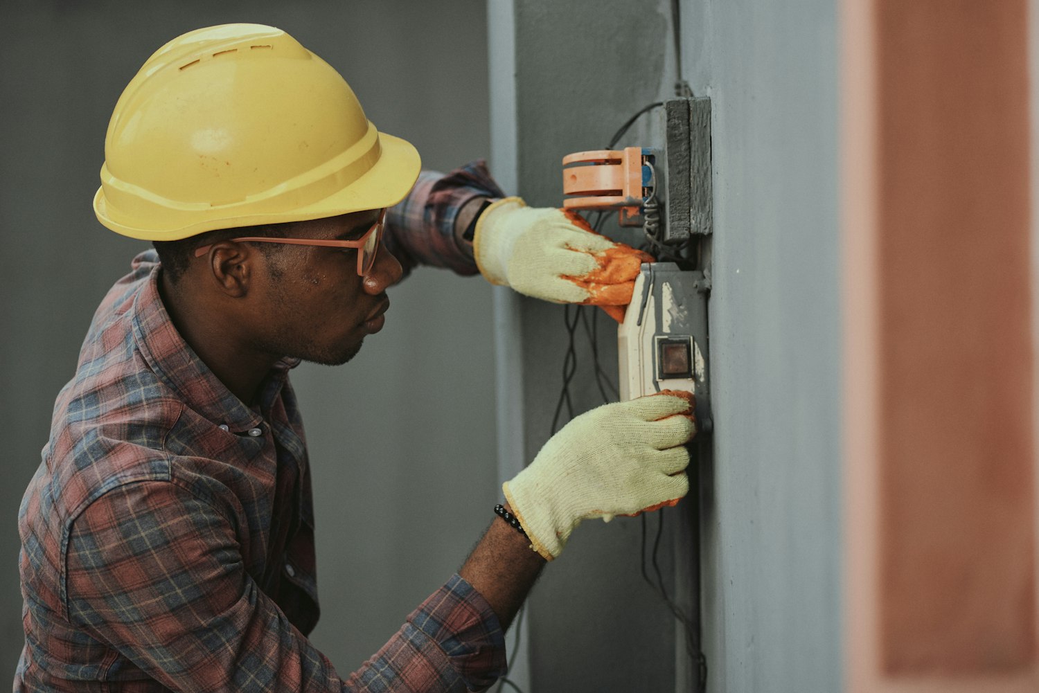 Electrician installing an electrical distribution box on site